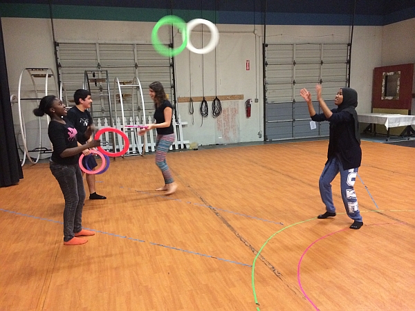 Youth from ReWA learn to juggle and pass rings.